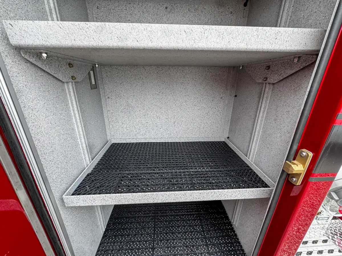 Open compartment interior view with shelf and empty floor area.
